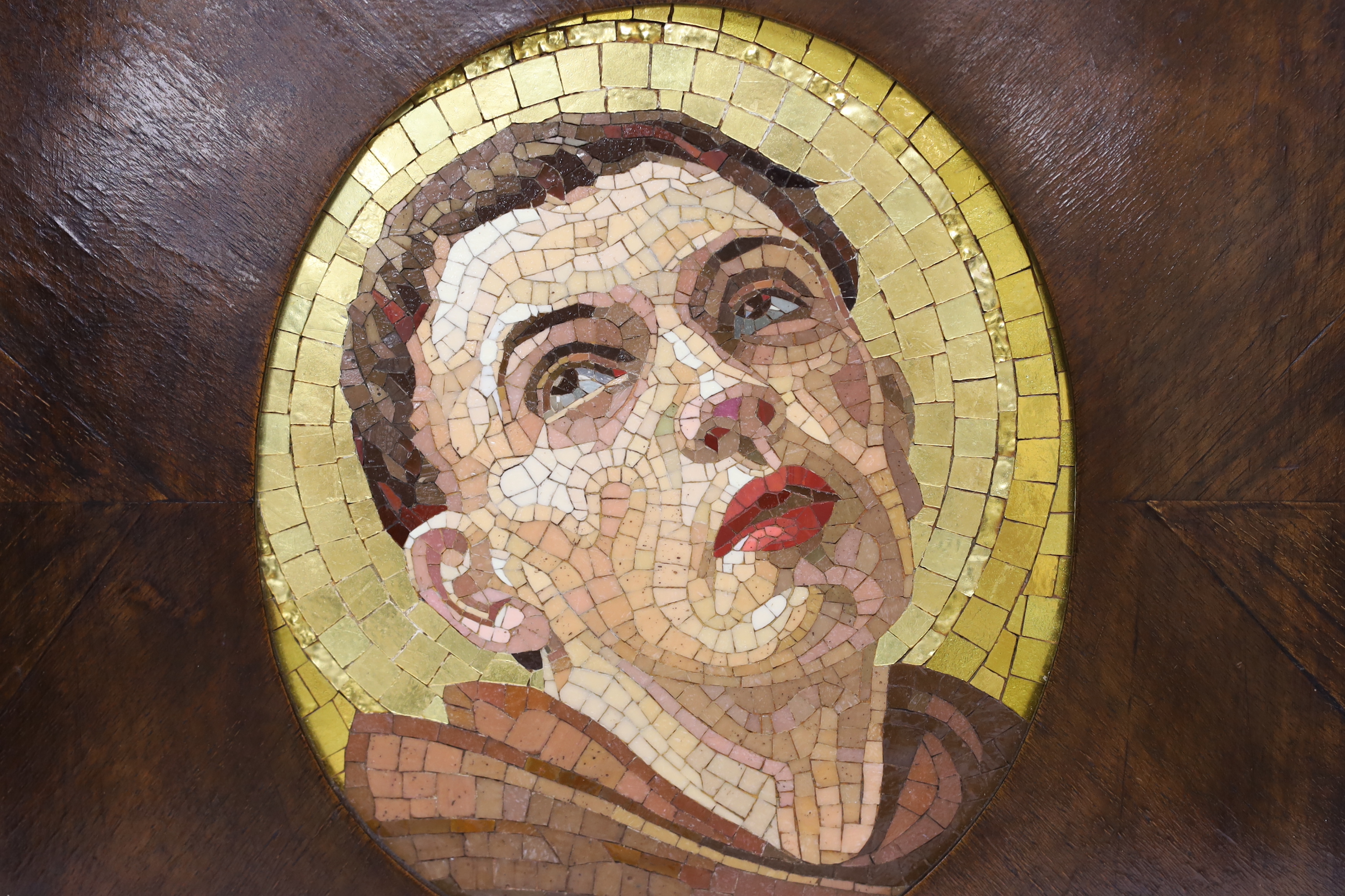 An Italian mosaic oval panel of a saint in a mahogany frame, panel 23cm high x 19cm wide